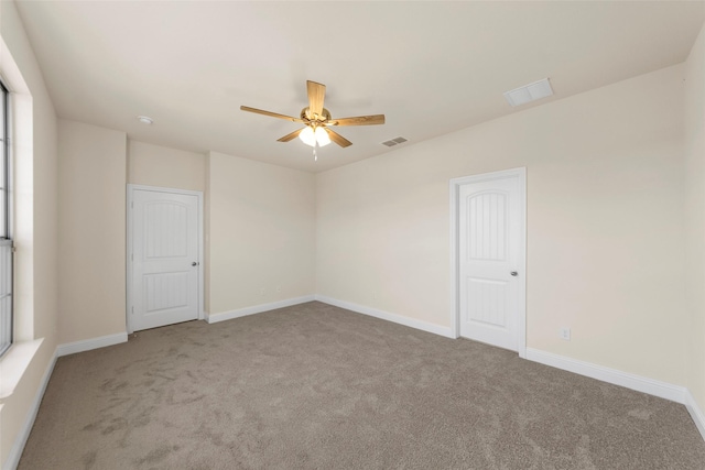 unfurnished room featuring light carpet and ceiling fan