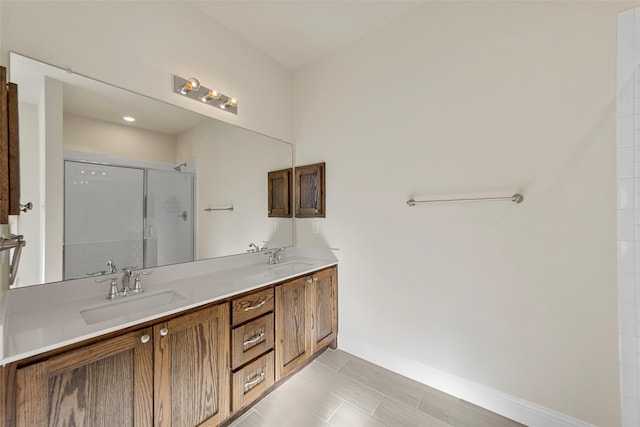 bathroom featuring tile patterned flooring, vanity, and a shower with shower door