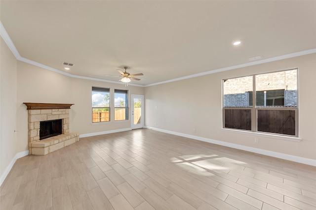 unfurnished living room featuring ceiling fan, a stone fireplace, crown molding, and light hardwood / wood-style flooring