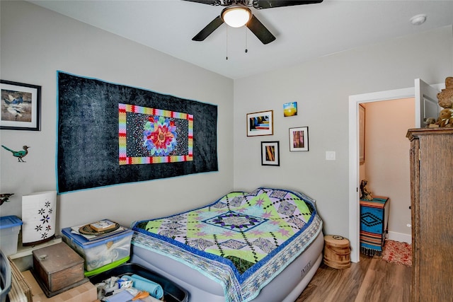 bedroom featuring hardwood / wood-style floors and ceiling fan