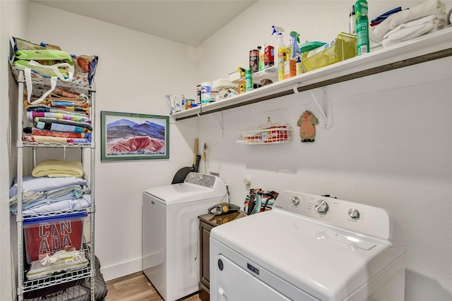 laundry area with light hardwood / wood-style flooring and independent washer and dryer