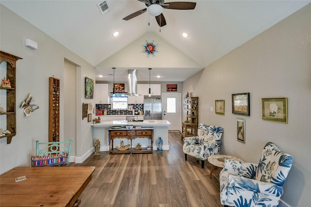 interior space with ceiling fan, sink, dark wood-type flooring, and high vaulted ceiling