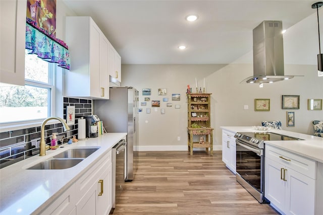 kitchen featuring stainless steel appliances, sink, island range hood, and white cabinets