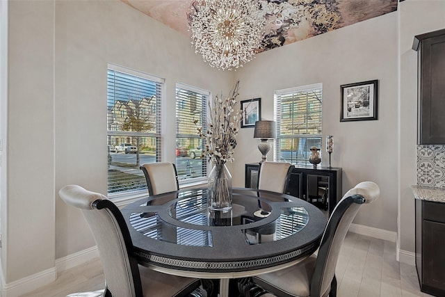 dining area featuring an inviting chandelier and light wood-type flooring