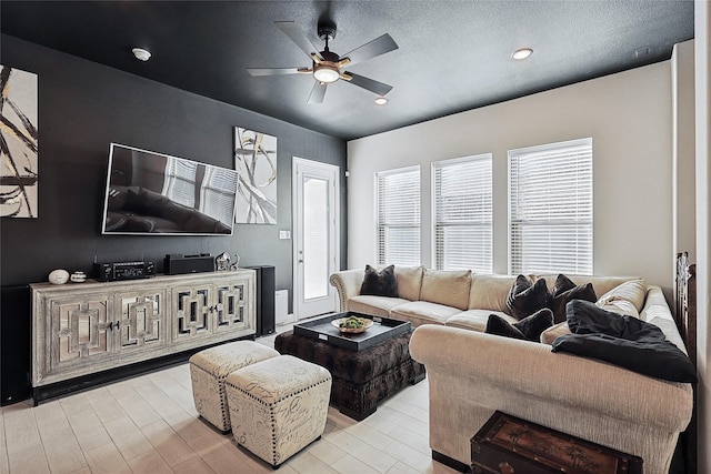 living room with ceiling fan and light hardwood / wood-style floors