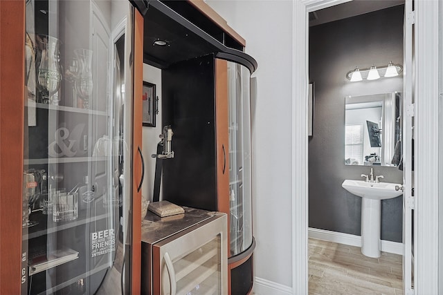 utility room featuring sink and wine cooler