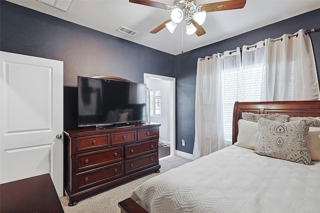 bedroom with ceiling fan and light carpet