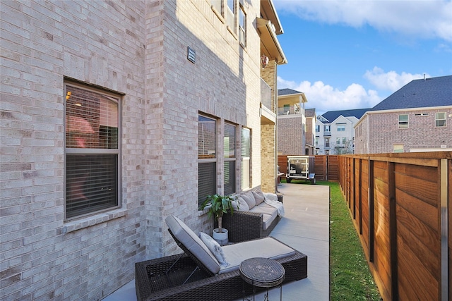 view of side of property with an outdoor living space and a patio area