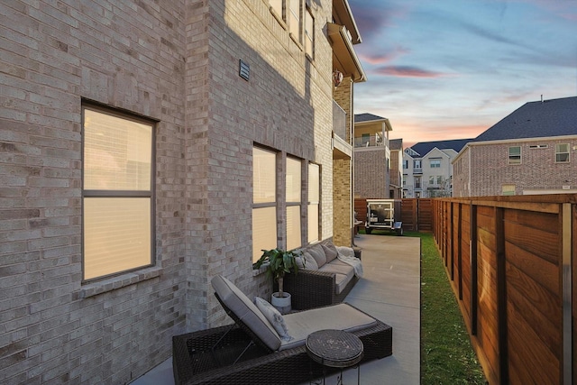 property exterior at dusk with a patio area and an outdoor hangout area