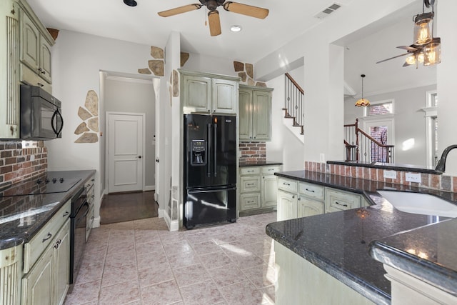 kitchen featuring sink, backsplash, pendant lighting, black appliances, and green cabinetry