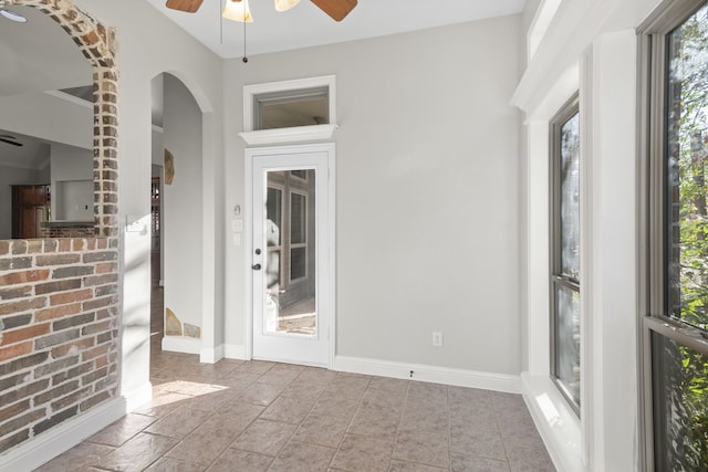 interior space with ceiling fan