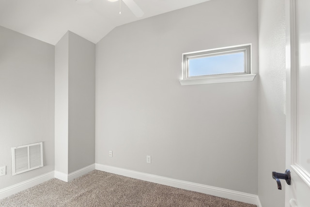 carpeted spare room featuring ceiling fan and lofted ceiling