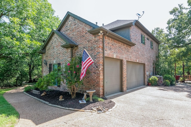 view of side of home featuring a garage