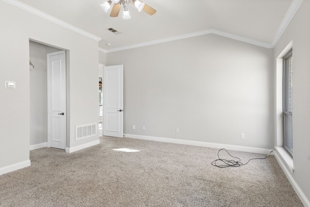 carpeted spare room featuring ceiling fan and crown molding