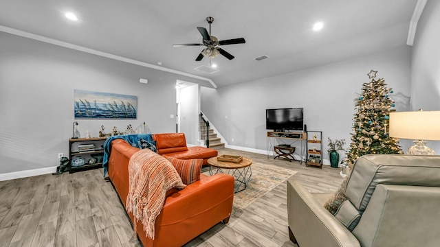 living room featuring light hardwood / wood-style flooring, ceiling fan, and ornamental molding