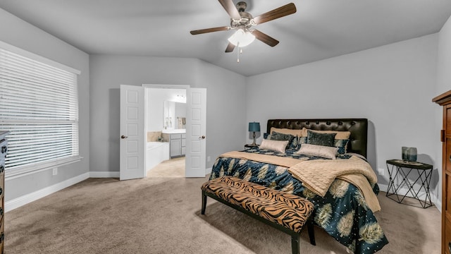 bedroom featuring ceiling fan, light colored carpet, lofted ceiling, and connected bathroom