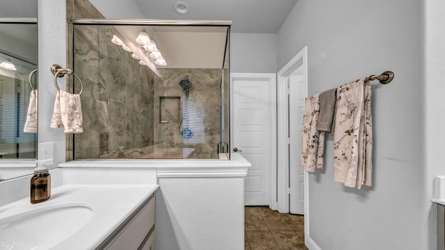 bathroom featuring tile patterned floors, vanity, and a shower with door