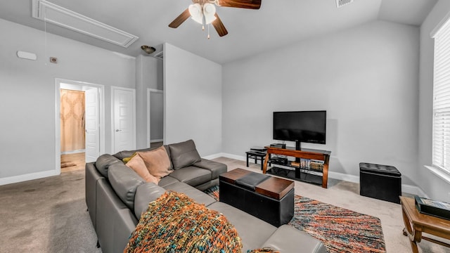 carpeted living room with ceiling fan, plenty of natural light, and lofted ceiling