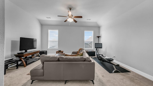 carpeted living room featuring lofted ceiling, ceiling fan, and a healthy amount of sunlight