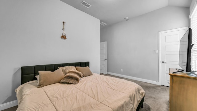 carpeted bedroom with lofted ceiling