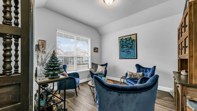 sitting room with hardwood / wood-style flooring and vaulted ceiling