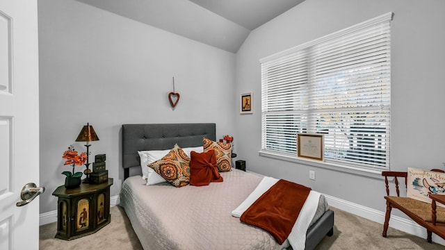 carpeted bedroom with lofted ceiling