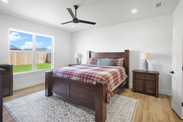 bedroom with ceiling fan and light wood-type flooring