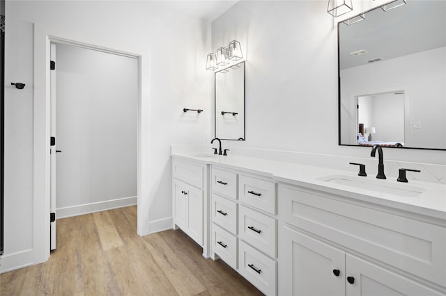 bathroom featuring hardwood / wood-style floors and vanity