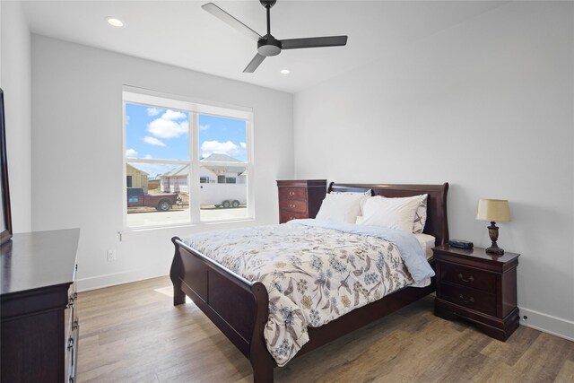 bedroom with ceiling fan and hardwood / wood-style flooring