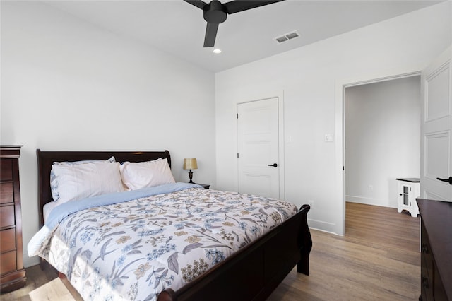 bedroom featuring ceiling fan, a closet, and light hardwood / wood-style flooring