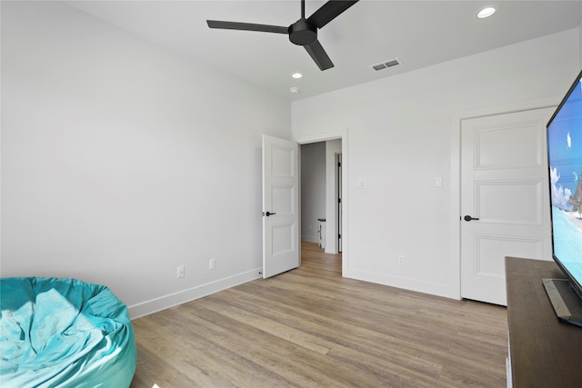 unfurnished room with ceiling fan and light hardwood / wood-style flooring