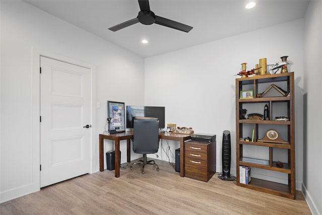 home office with light wood-type flooring and ceiling fan