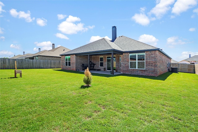 back of property featuring a lawn and a patio area