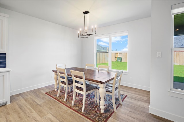 dining room featuring light hardwood / wood-style flooring and a chandelier