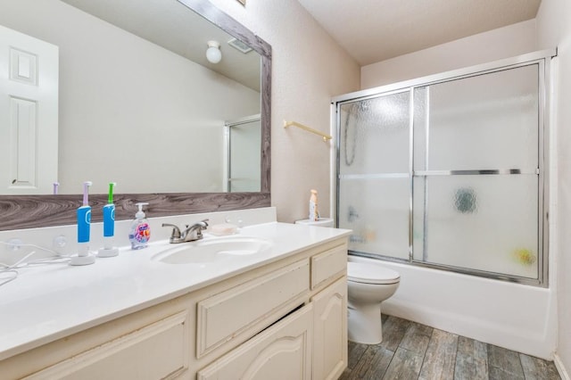 1330 Lyra Ln, Arlington, TX 76013 - bathroom with shower / bath combination with glass door, vanity, toilet, and wood finished floors