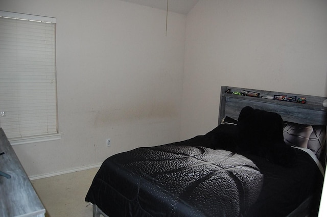 bedroom with carpet and baseboards