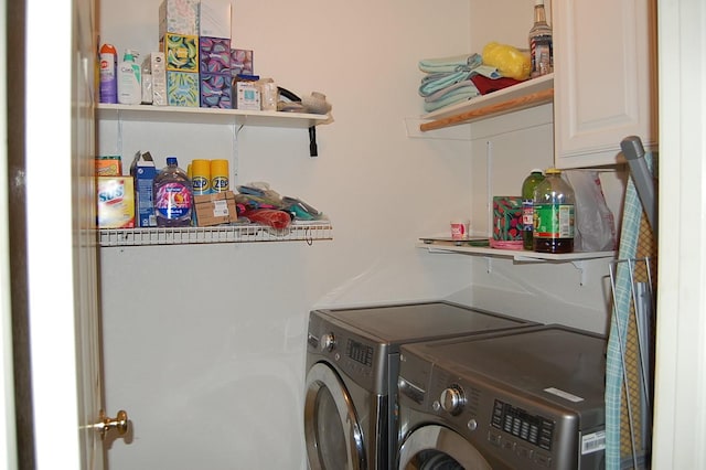 laundry area with cabinet space and separate washer and dryer