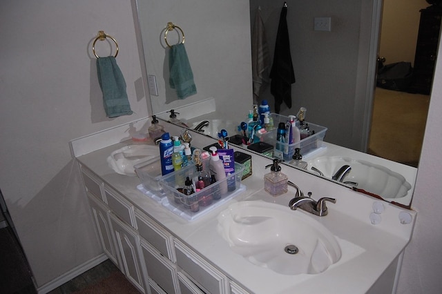 bathroom with a sink and double vanity