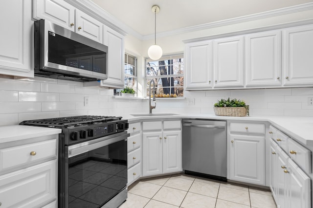 kitchen with light tile patterned floors, white cabinetry, sink, and appliances with stainless steel finishes