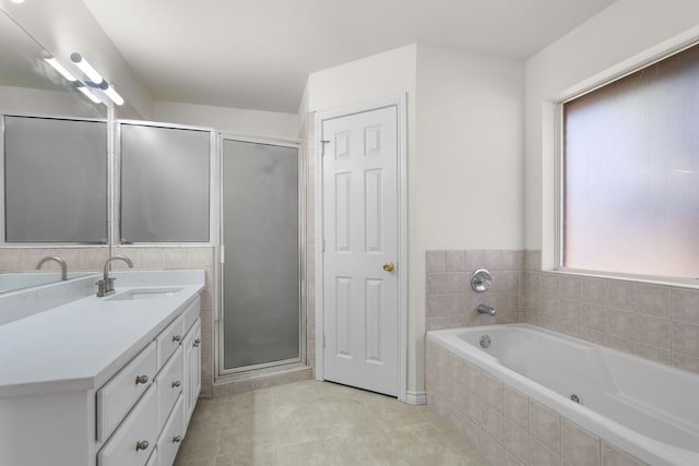 bathroom with separate shower and tub, plenty of natural light, vanity, and tile patterned flooring