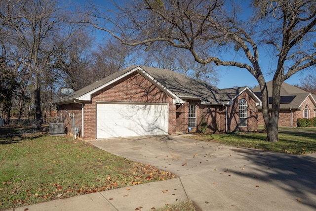 view of front of property with a garage, central AC, and a front yard