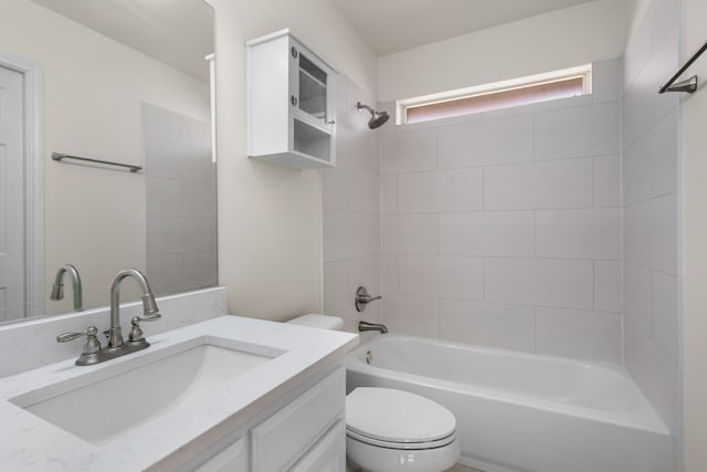 full bathroom with vanity, toilet, and tiled shower / bath