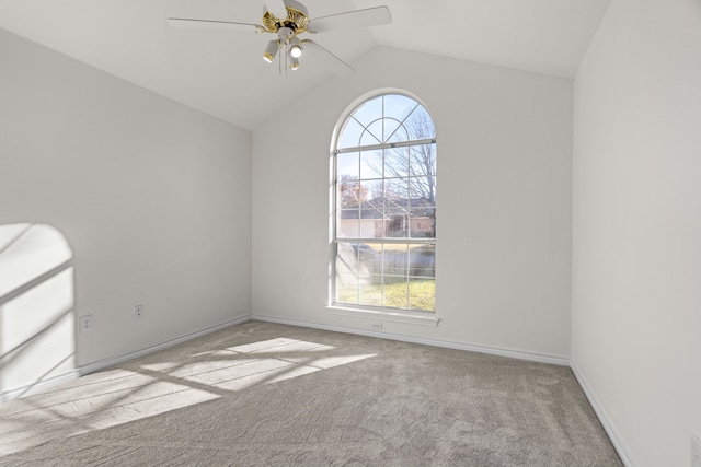 empty room featuring ceiling fan, light colored carpet, and vaulted ceiling