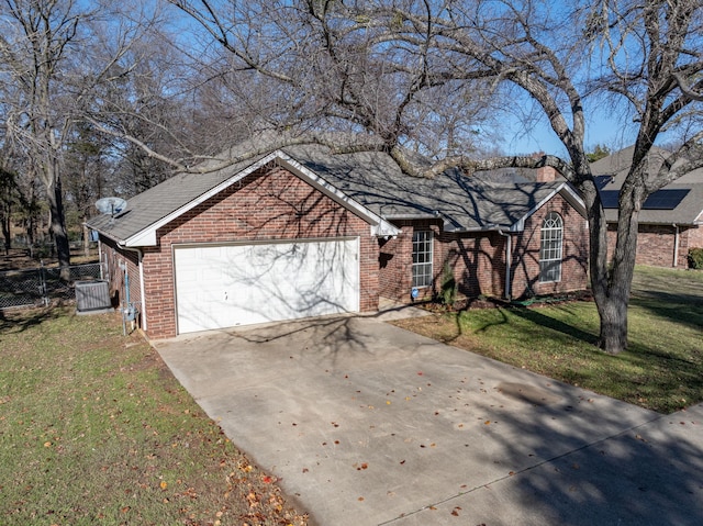 view of front of house featuring a garage and a front lawn