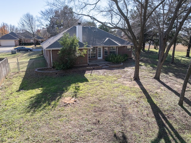 rear view of house with a yard