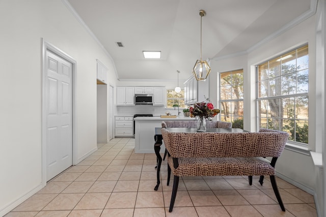 dining room featuring lofted ceiling, crown molding, light tile patterned floors, and an inviting chandelier