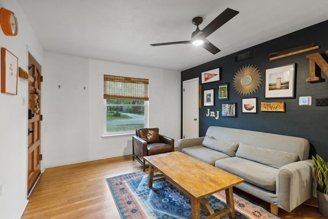 living room with ceiling fan and light wood-type flooring