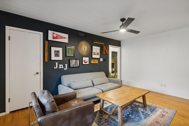 living room featuring ceiling fan and wood-type flooring