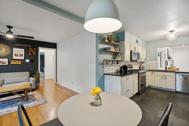 dining room with ceiling fan and sink