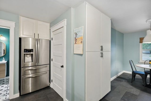 kitchen with white cabinets and stainless steel fridge